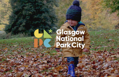 Glasgow National Park City logo with a child playing in leaves.