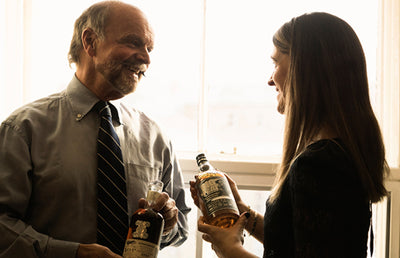 Two people at Douglas Laing talking over Whisky.