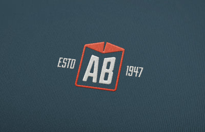 AB Handling logo printed on clothing material.