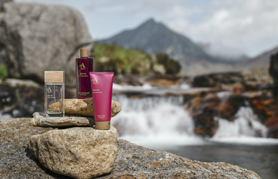 Three Arran products on rocks beside a river.