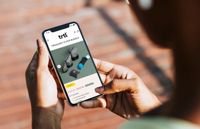 Someone exploring the TRTL travel website on an iPhone.