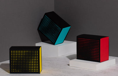 Three black blocks laid out artistically on 3 grey smaller blocks.