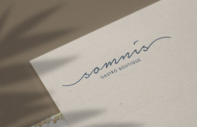 Somni's Gasto Boutique logo on a piece of card.