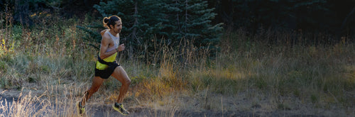 A person running through grass.