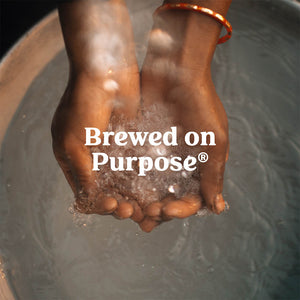 A pair of hands cupped holding water.