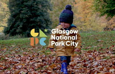 Glasgow national park city banner with a child playing in leaves.